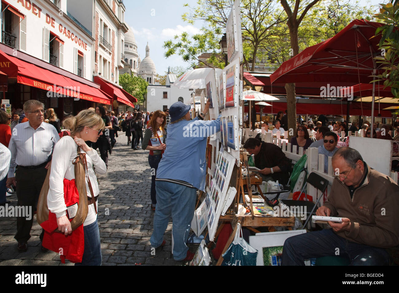 Tourists browse artist stalls at Place du Tertre in Montmartre, Paris, France Stock Photo