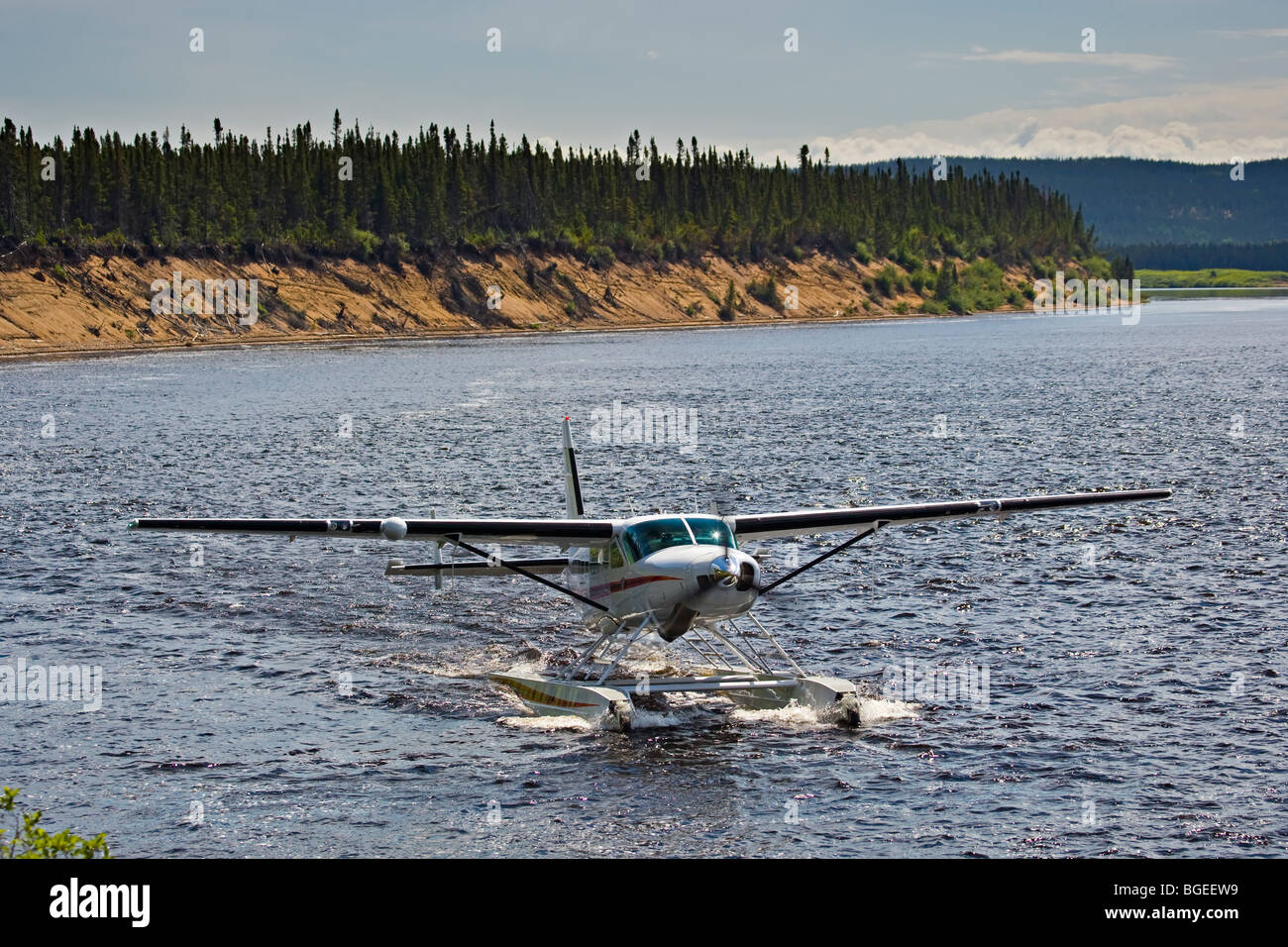 Cessna Caravan amphibian airplane landing on Eagle River at Rifflin'Hitch Lodge in Southern Labrador, Labrador, Newfoundland Lab Stock Photo