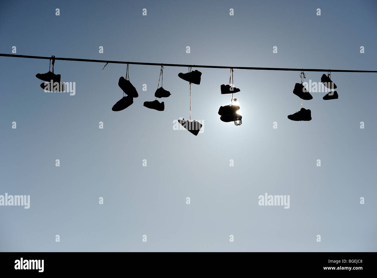 Shoes hanging from power line Stock Photo Alamy