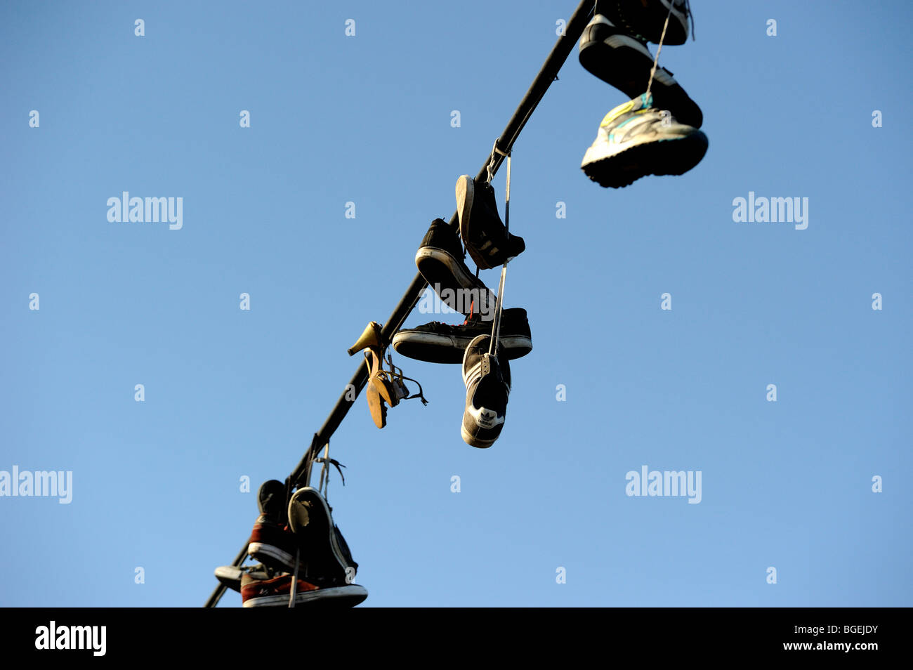 Shoes hanging from power line Stock Photo Alamy