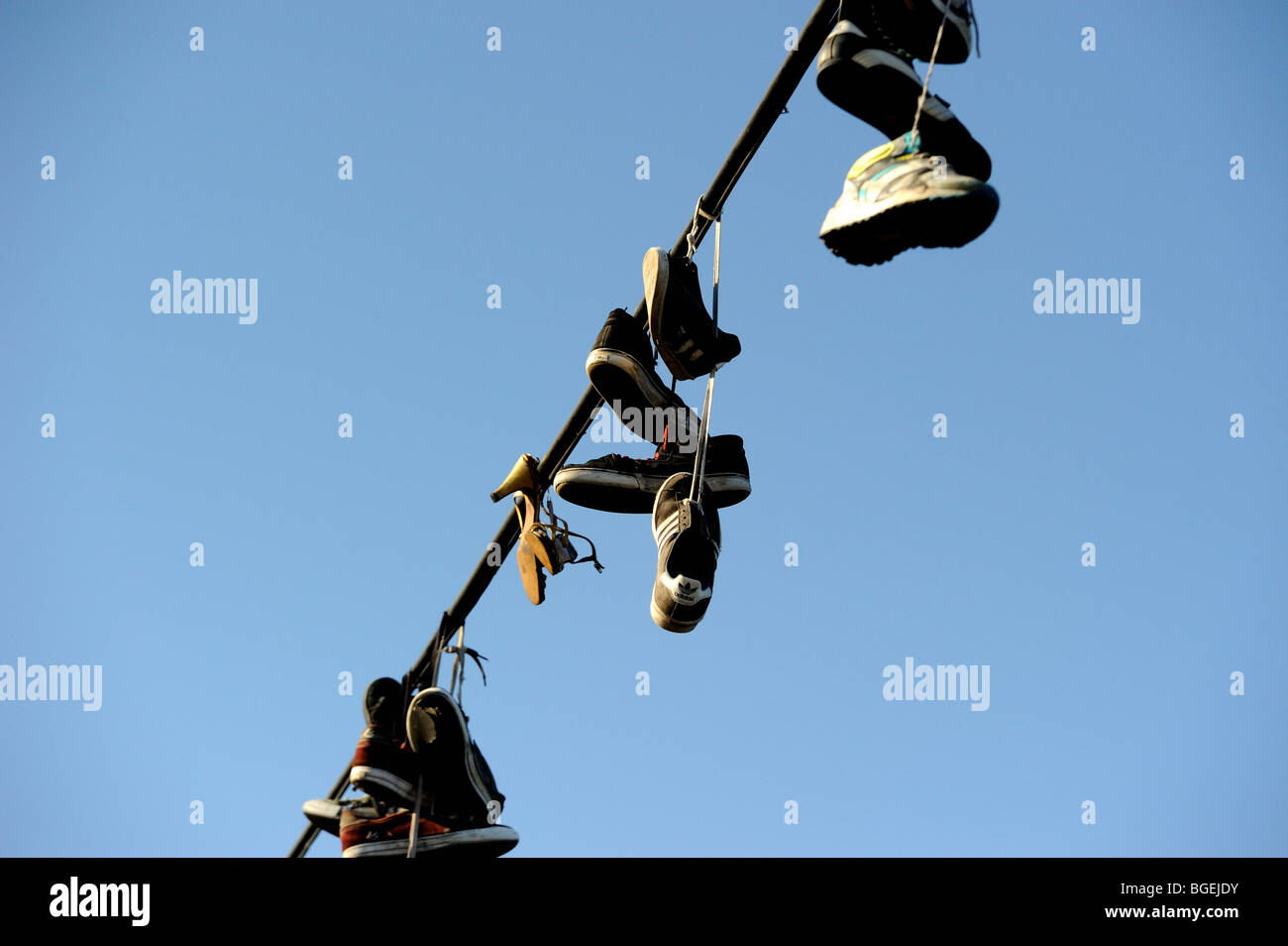 Shoes hanging from power line Stock Photo