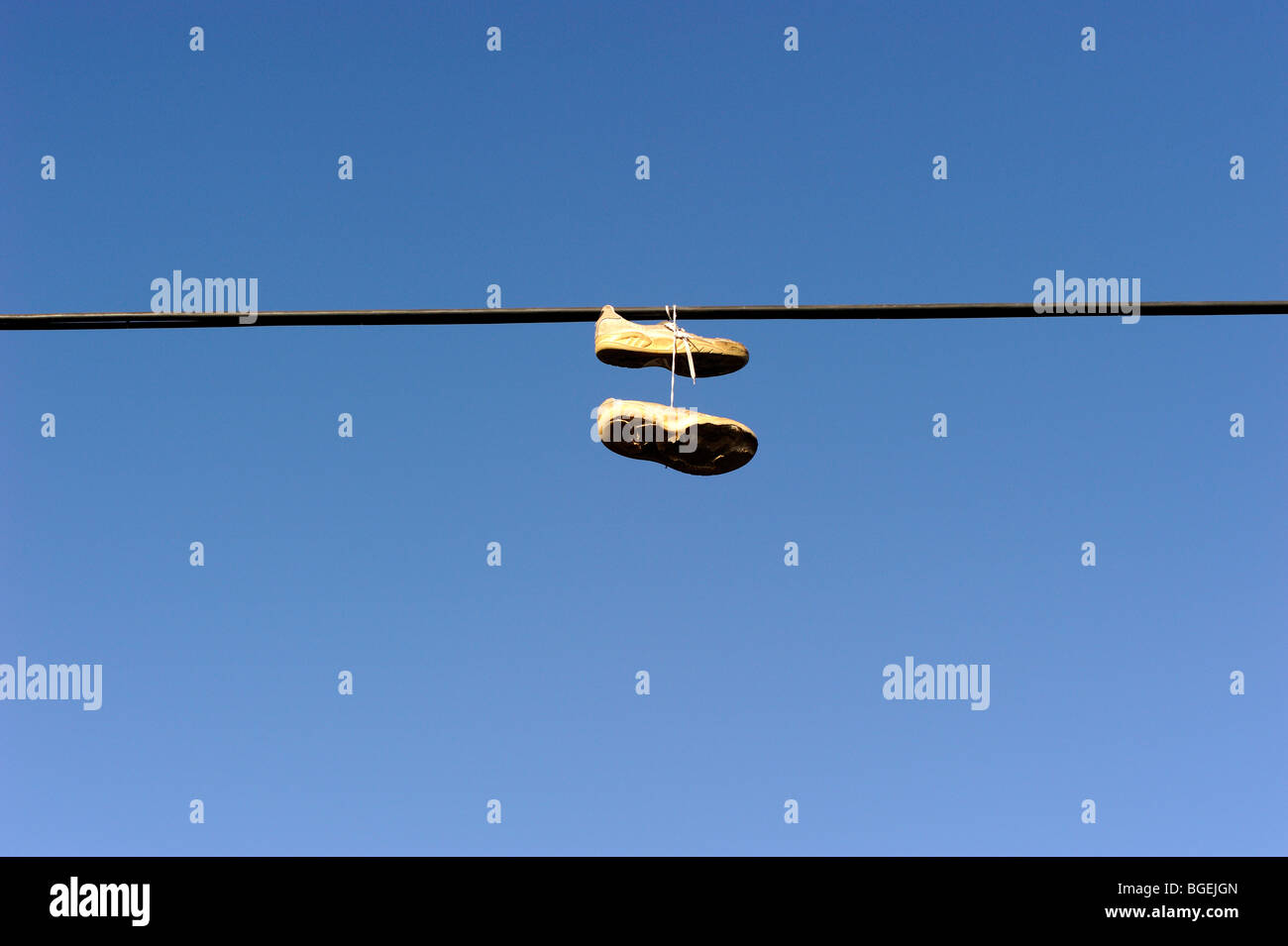 Shoes hanging from power line Stock Photo Alamy