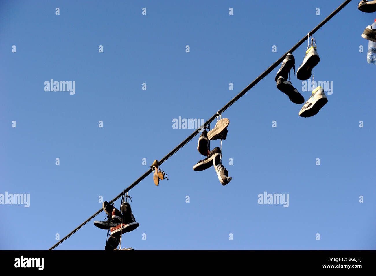 Shoes hanging from power line Stock Photo Alamy