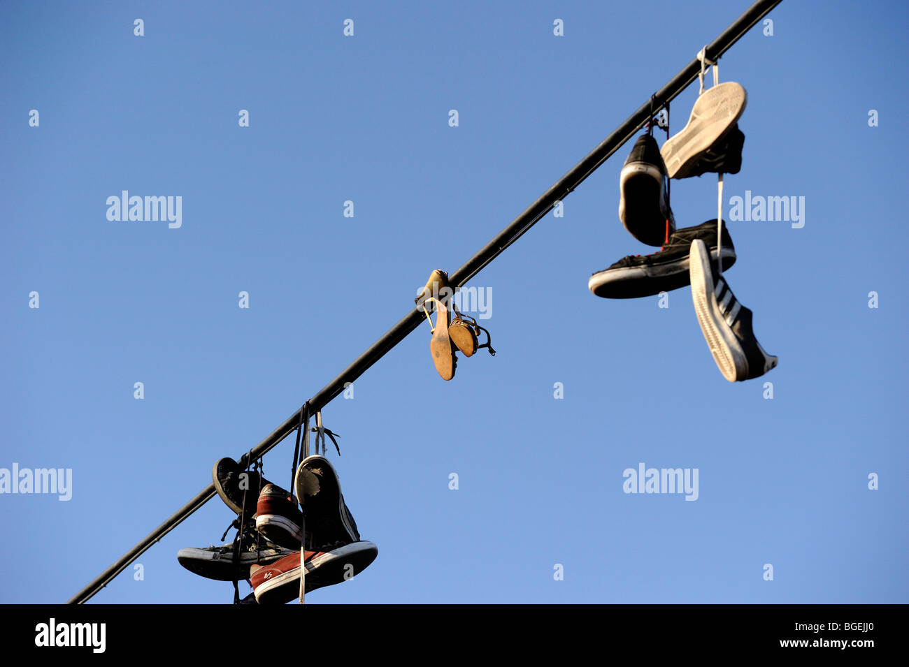 Shoes hanging from power line Stock Photo Alamy