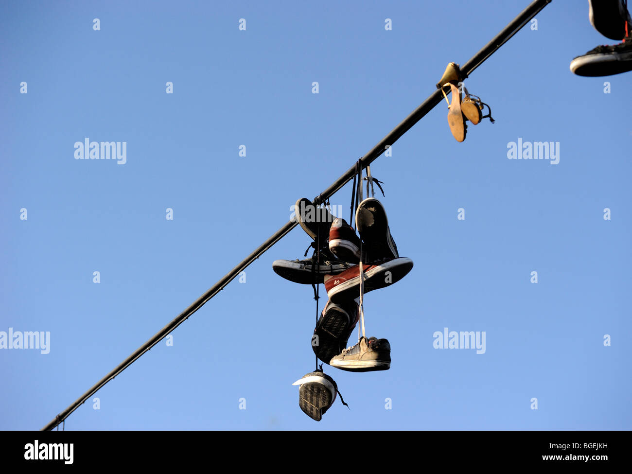 Shoes hanging from power line Stock Photo Alamy