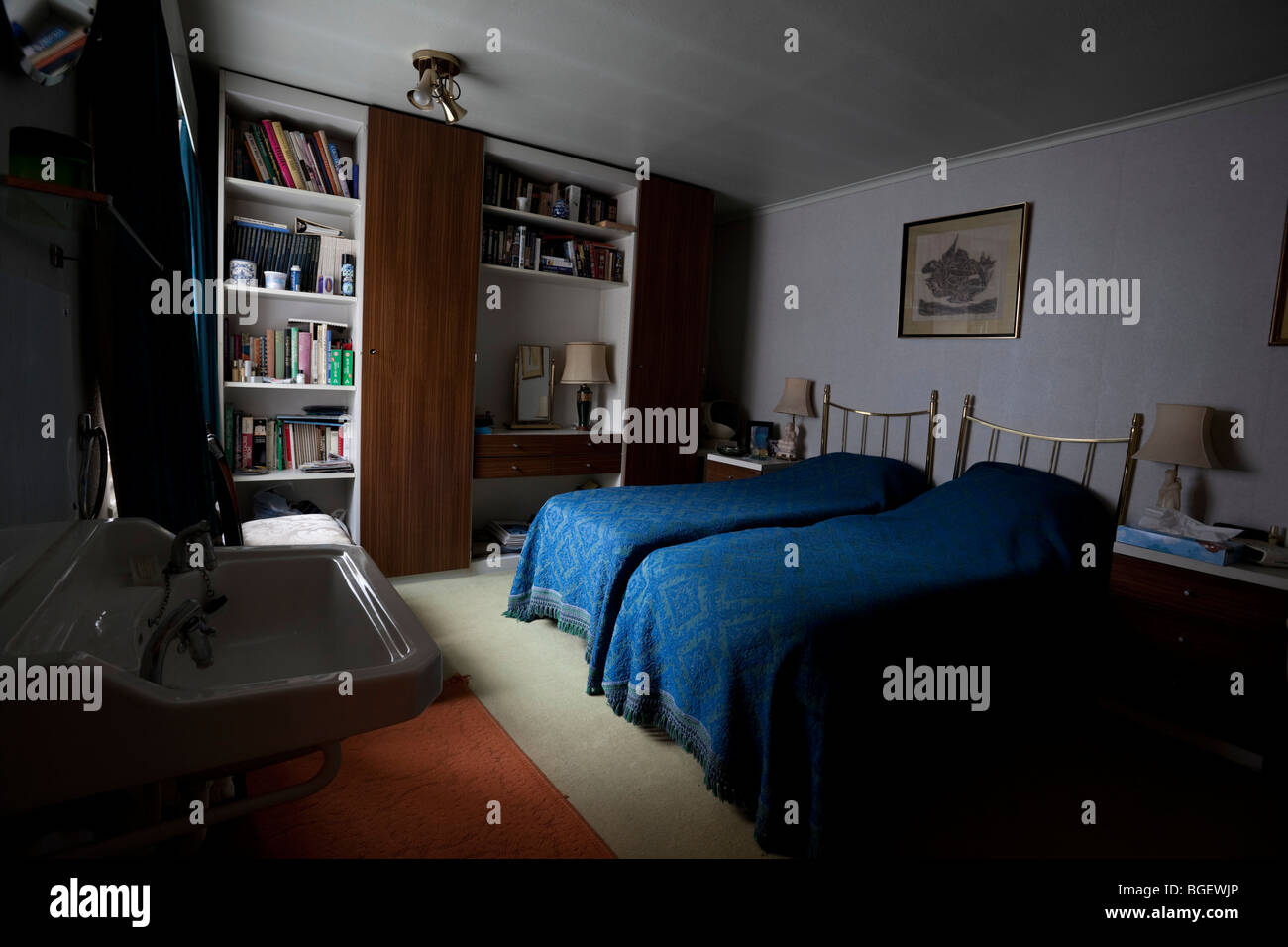 Interior photograph of an old fashion bedroom with two single beds