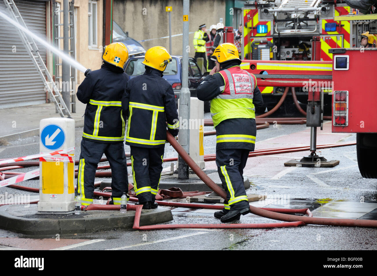Firemen fighting fire at retail shop Stock Photo Alamy