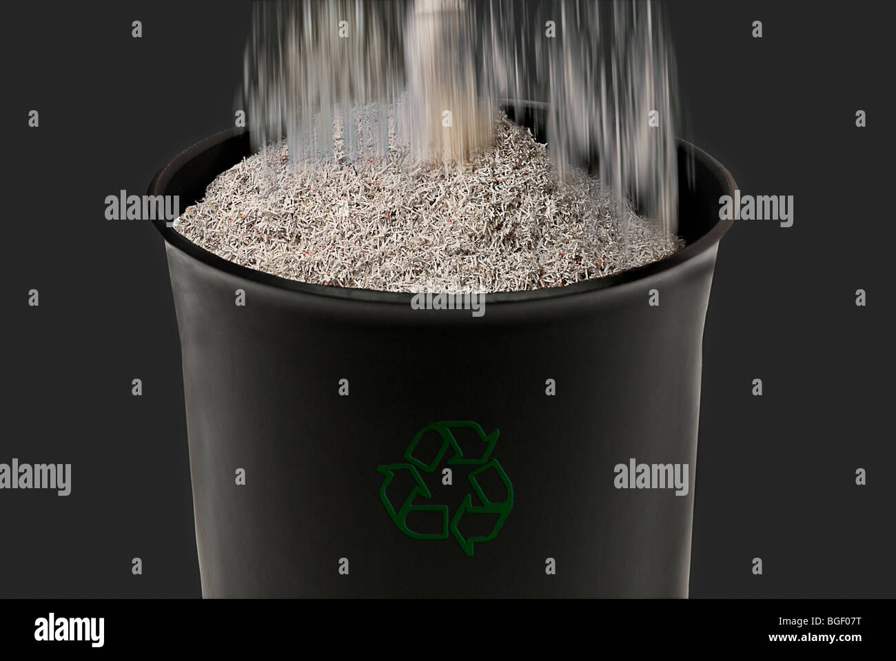 Shredded paper falling into a recycle bin, studio shot Stock Photo Alamy