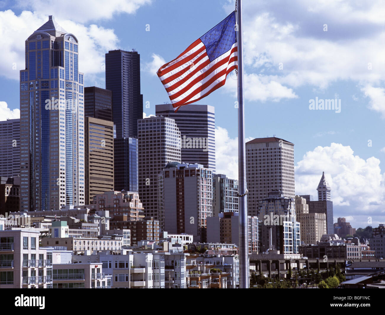 Downtown skyline with the Stars and Stripes flag in foreground and the city buildings beyond. Seattle, Washington State, USA. Stock Photo
