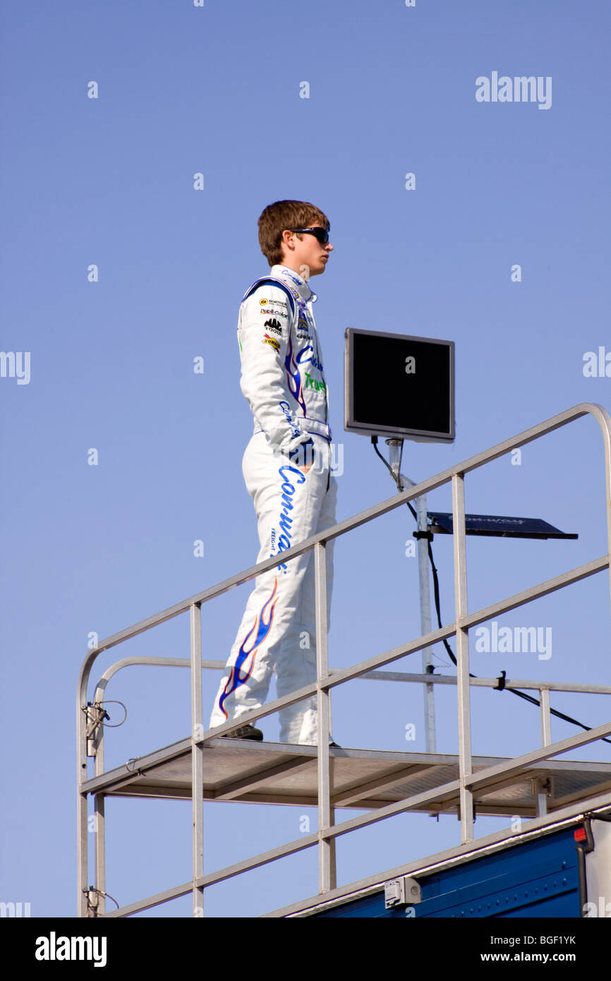 Colin Braun stands on his race trailer to watch qualifying. Stock Photo