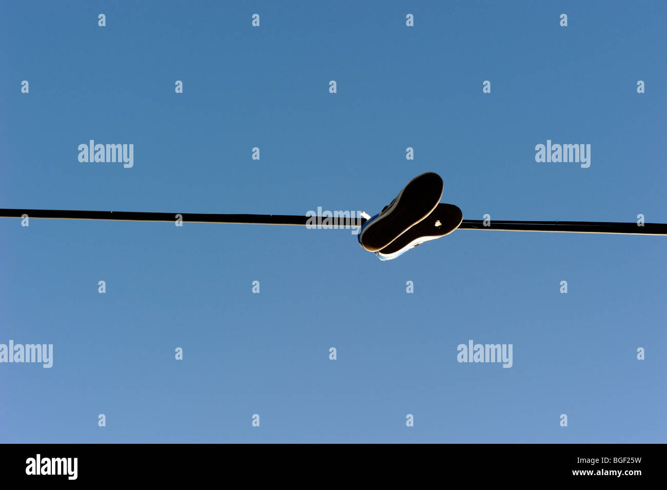 Shoes hanging from power line Stock Photo Alamy