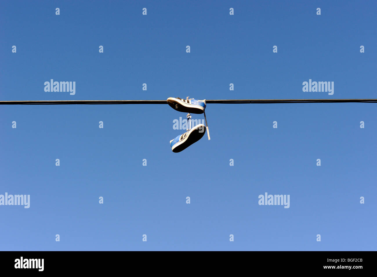 Shoes hanging from power line Stock Photo Alamy