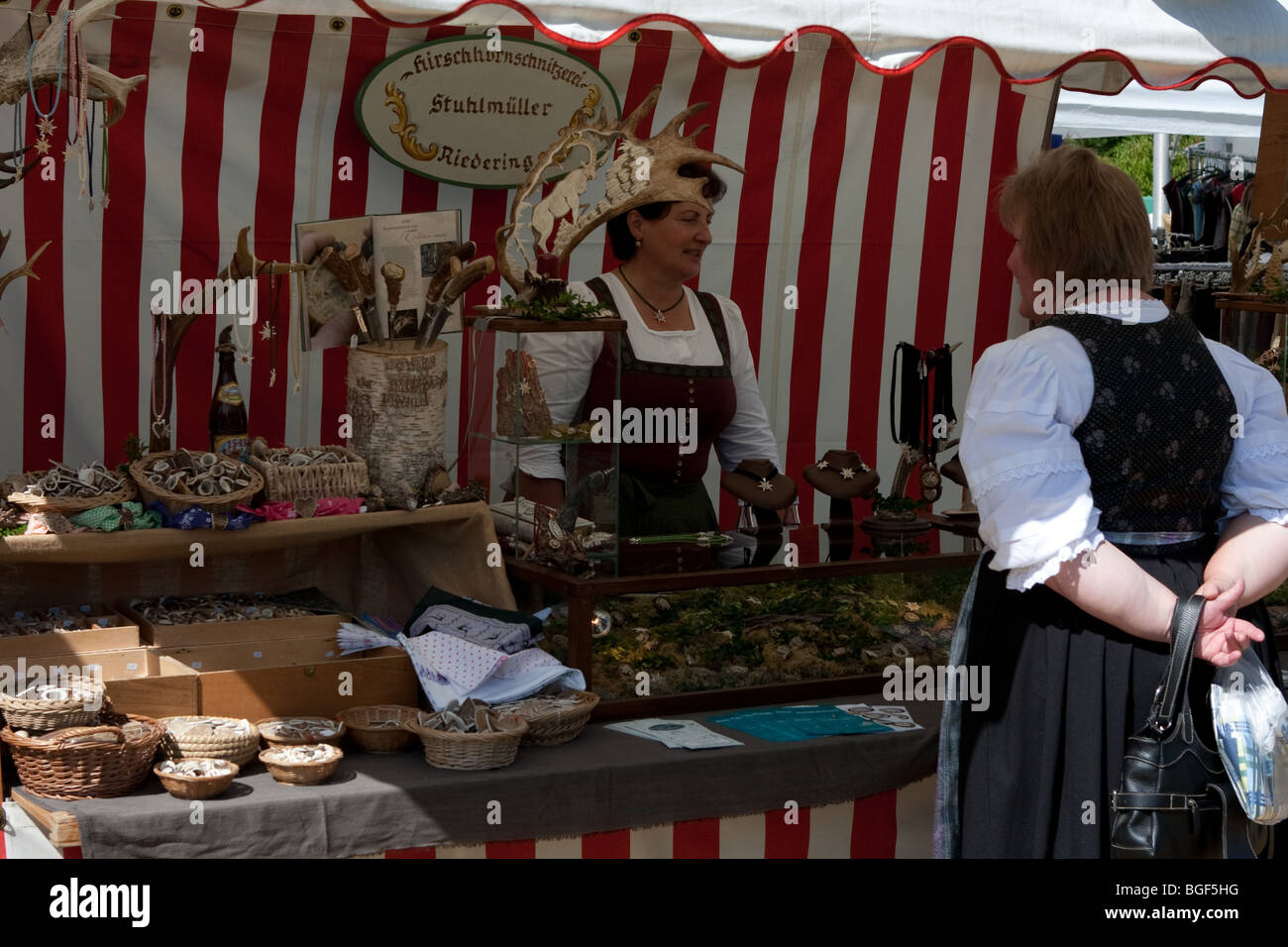 Customer buying articles from a stall in Bavaria in Southern Germany Stock Photo