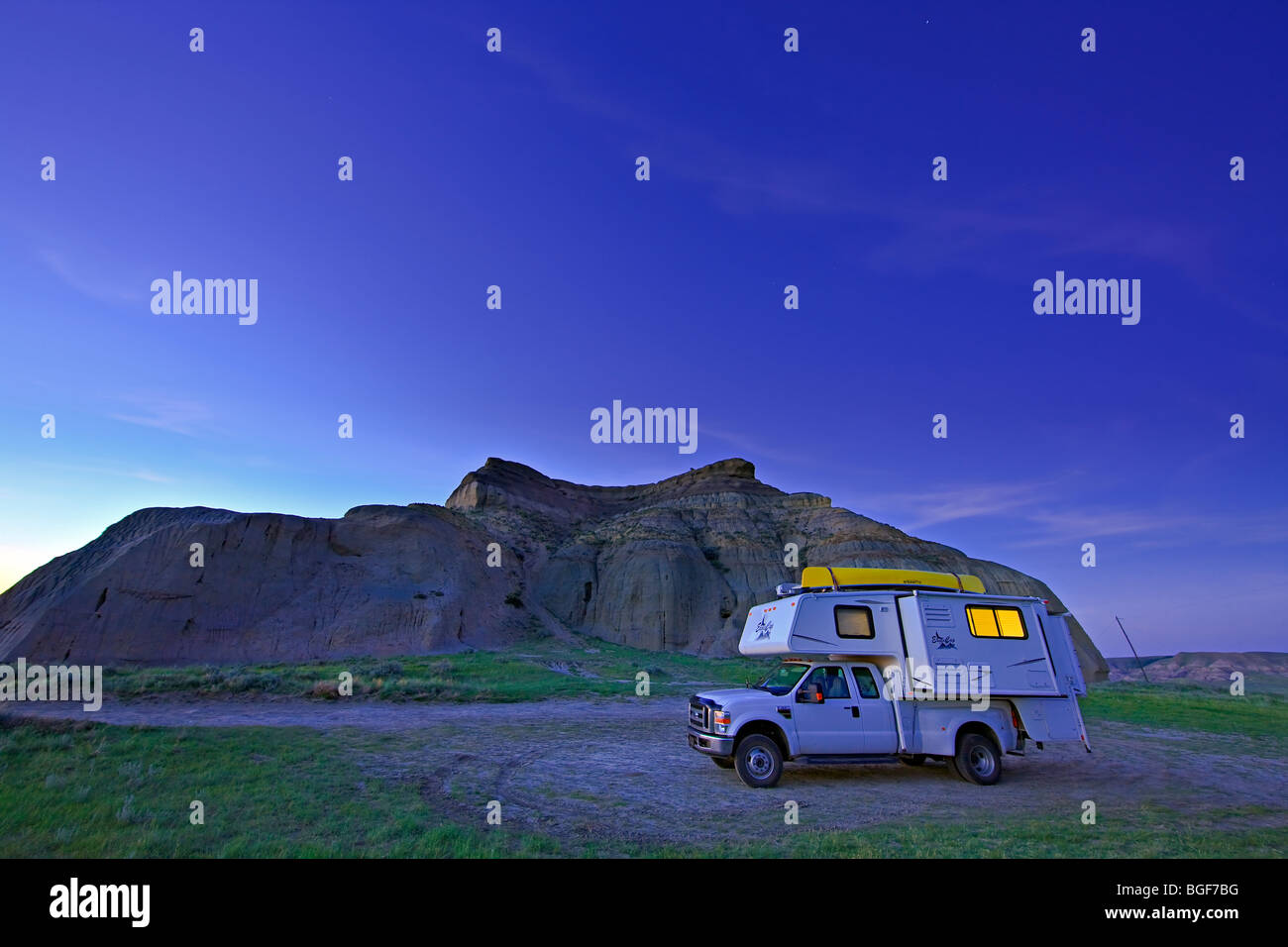 Camper at Castle Butte at dusk in the Big Muddy Badlands of Southern Saskatchewan, Canada. Stock Photo