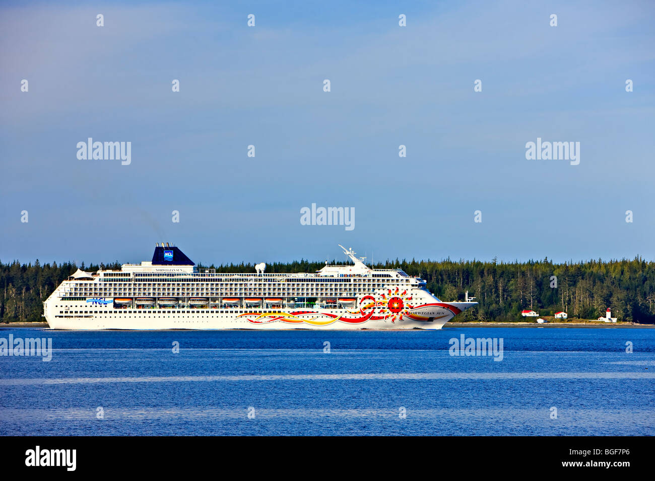 Norwegian Sun Cruise ship near Pultenay Point Lighthouse on Malcolm Island, Inside Passage, British Columbia, Canada. Stock Photo