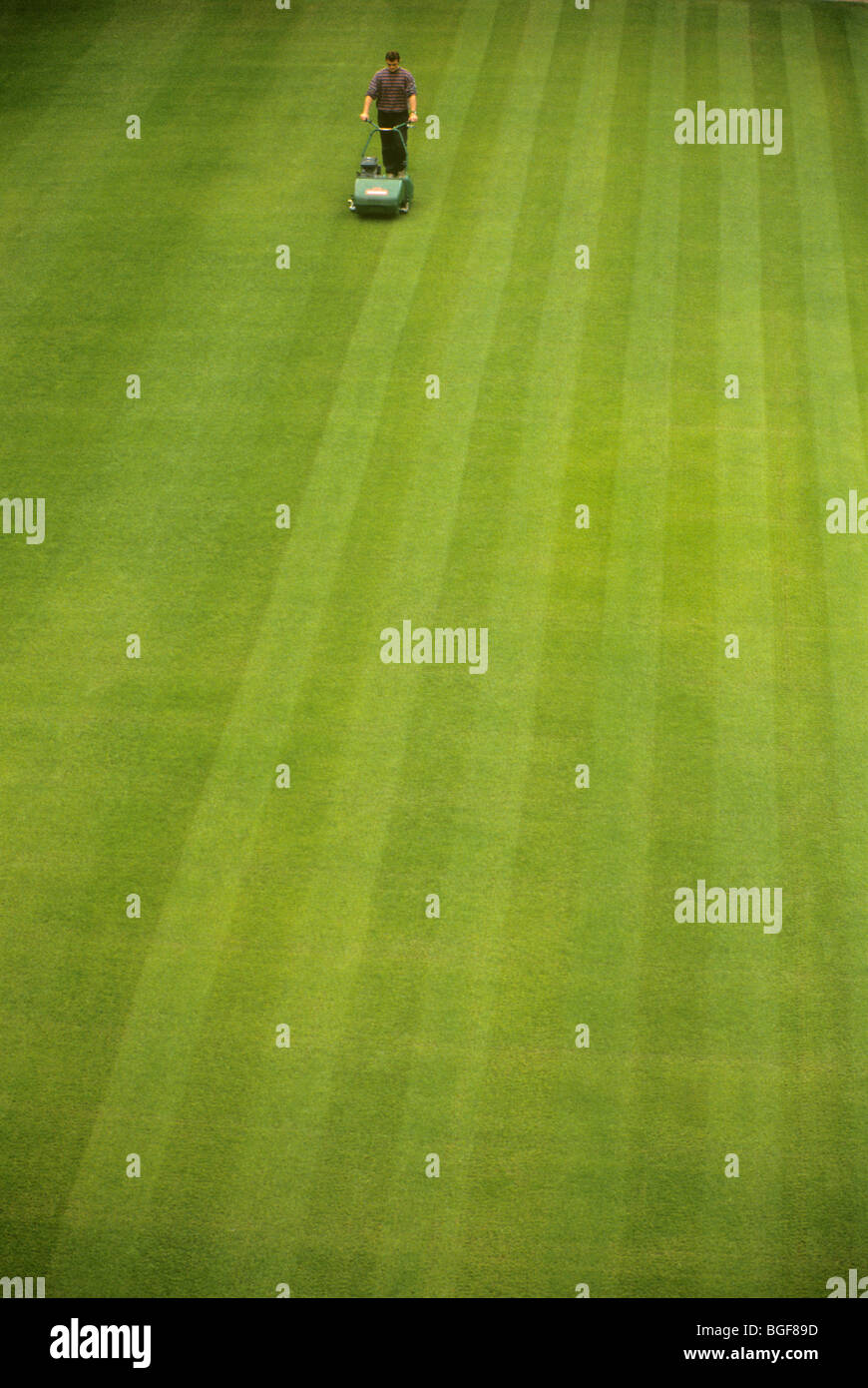 Groundsman / man / gardener mowing the lawn. UK Stock Photo Alamy