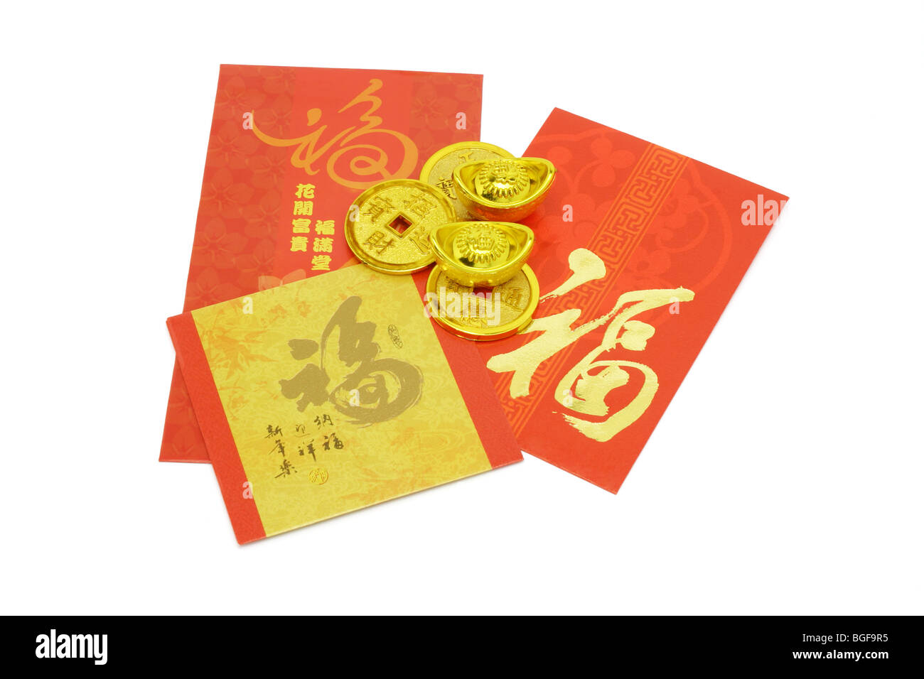 Chinese New Year ornaments gold coins, ingots and red packets Stock Photo