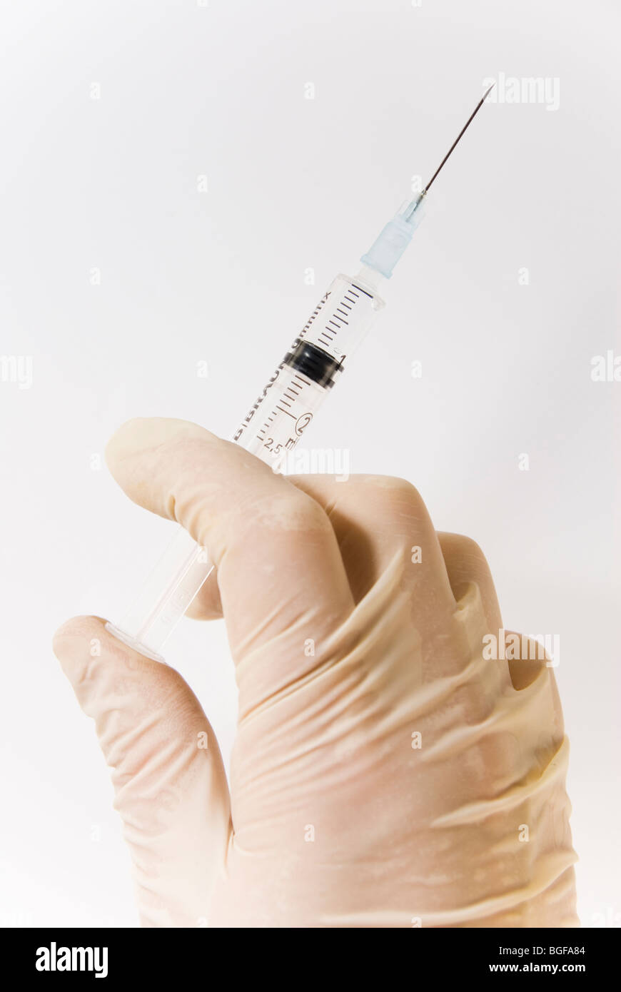 Gloved Hand Holding Hypodermic Needle Syringe Isolated on White Stock