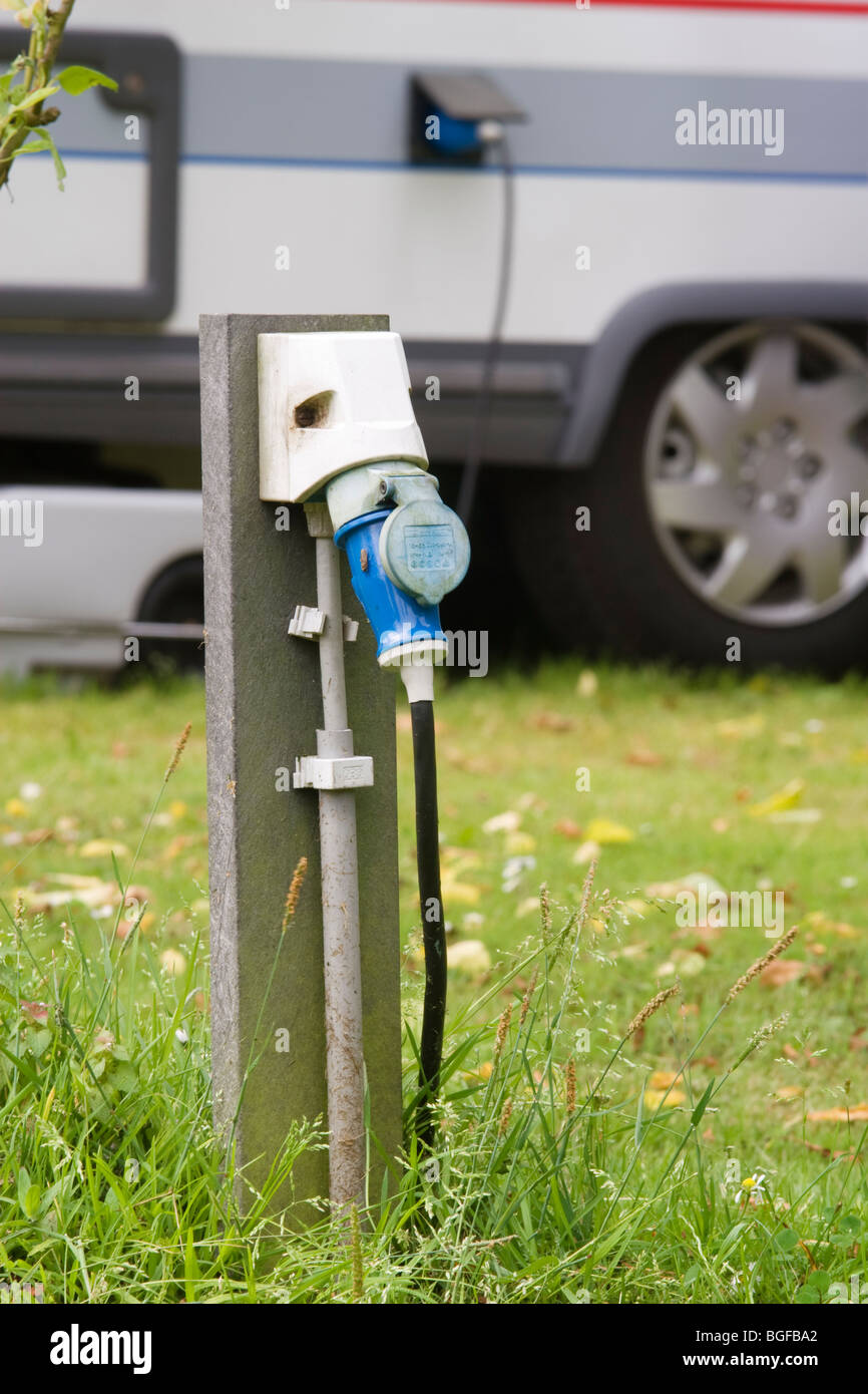 Caravan with electricity supply at a camping Stock Photo Alamy