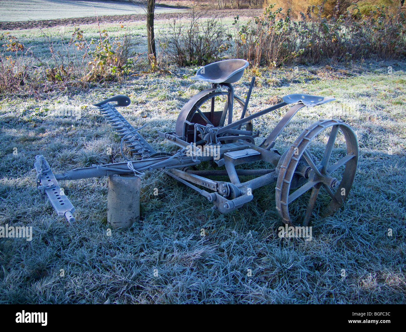 Old mower for the grain - frost at dawn Stock Photo