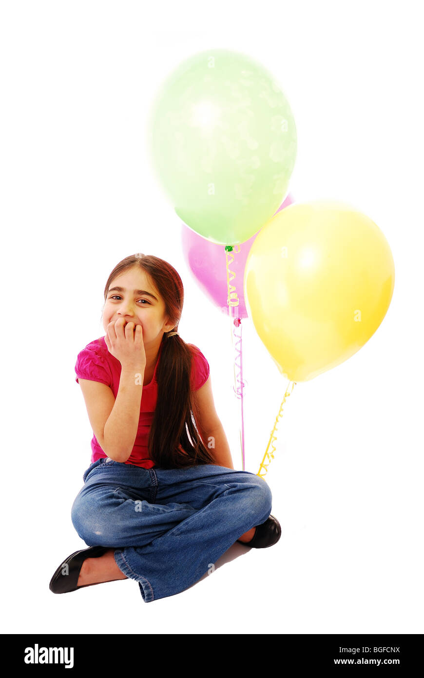 Young girl holding three balloons Stock Photo