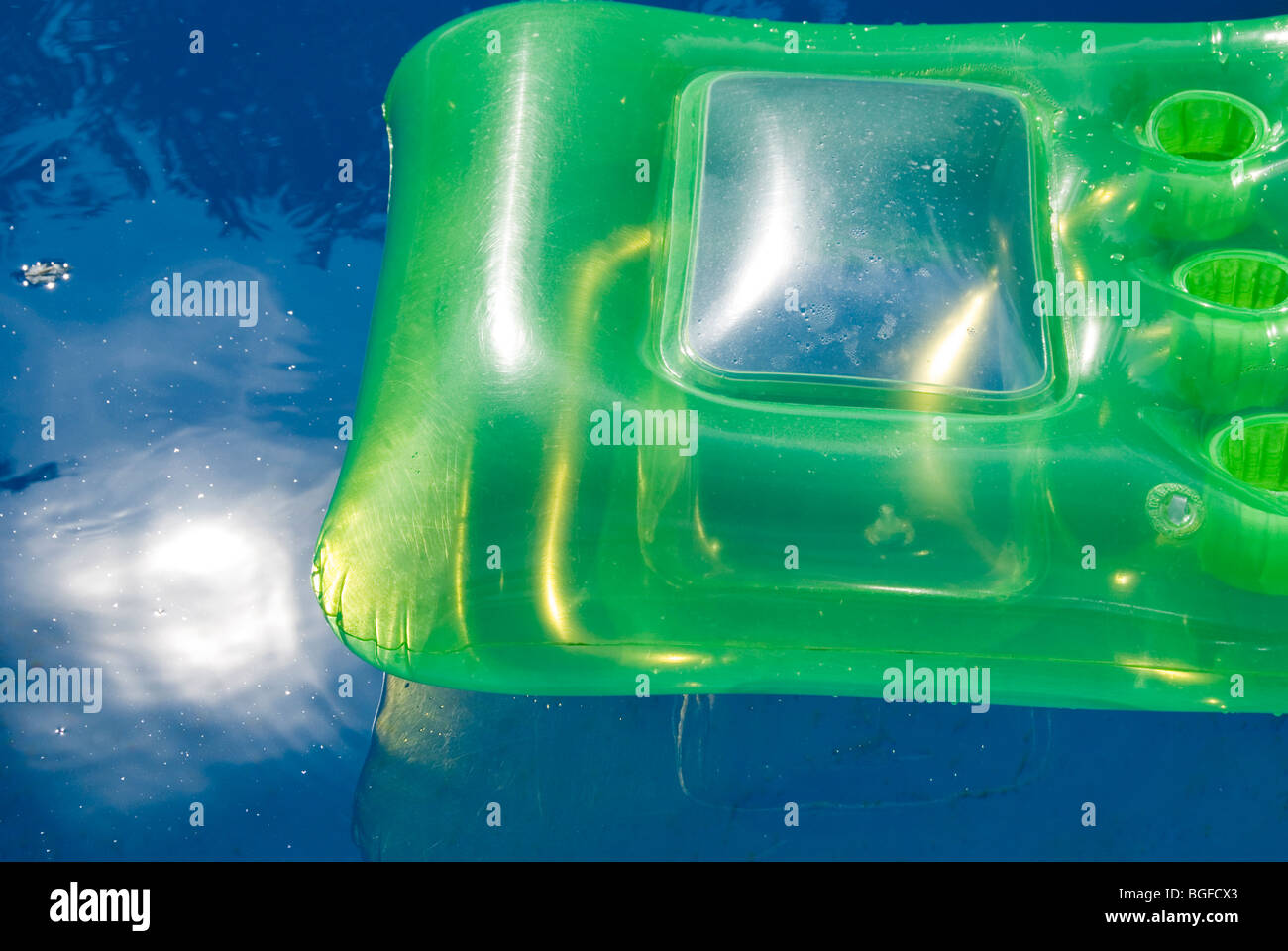 Section of inflatable sun bed floating in swimming [pool Stock Photo