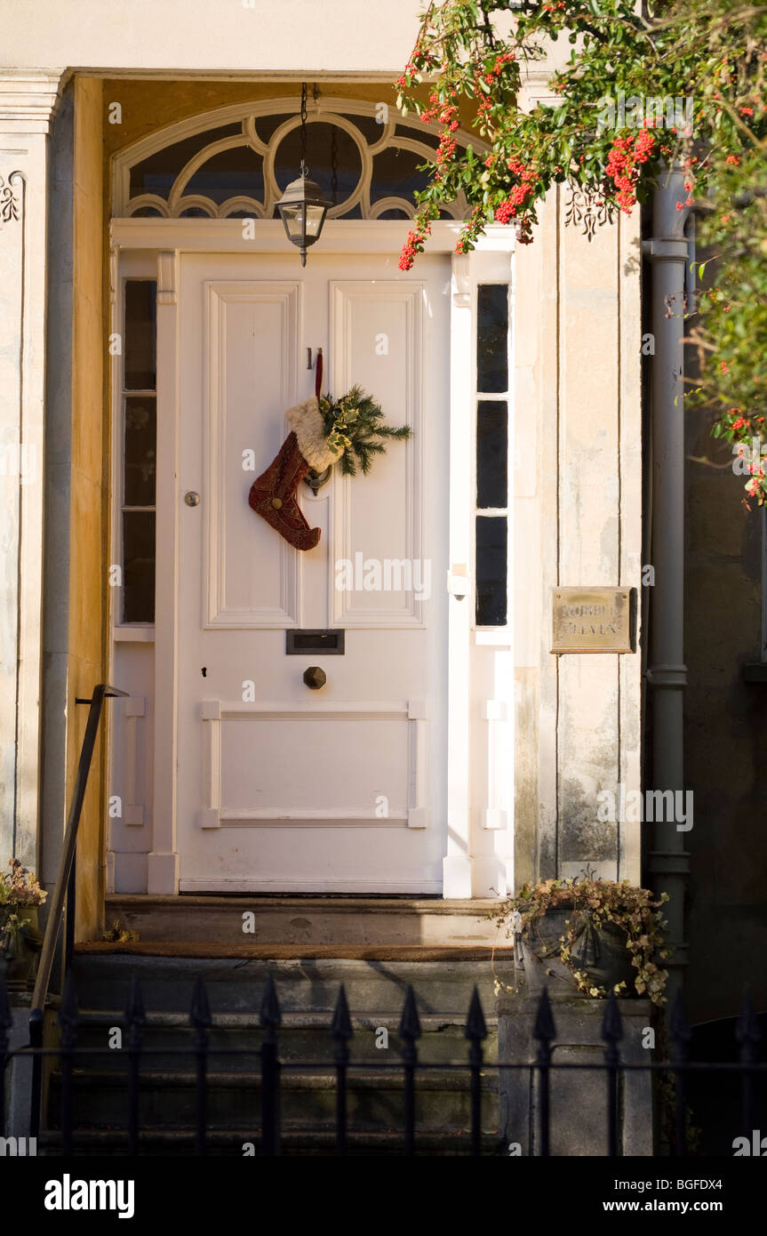 A traditional Regency door / entrance, to an English Town House - with an enchanting Christmas stocking providing a warm welcome Stock Photo