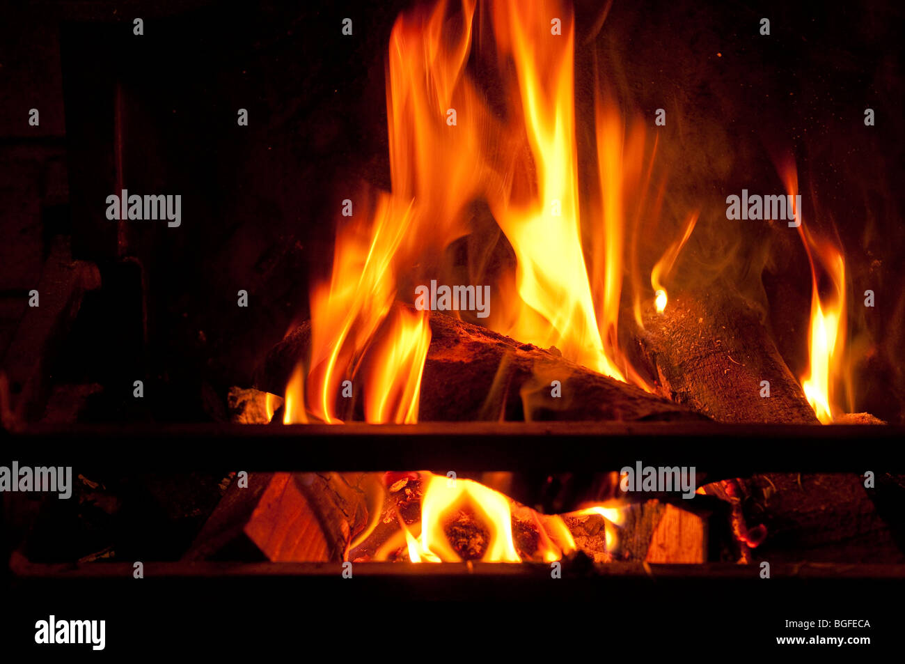 A log and coal fire burning fiercely - burning carbon / fossil fuels. Stock Photo