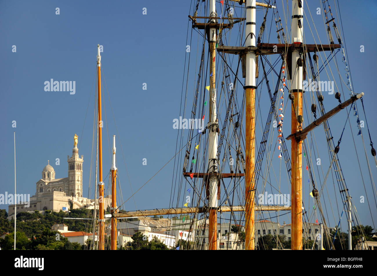 Notre-Dame de la Garde Church & Wooden Yacht Masts in Old Port, Vieux Port or Harbour, Marseille or Marseilles, Provence, France Stock Photo