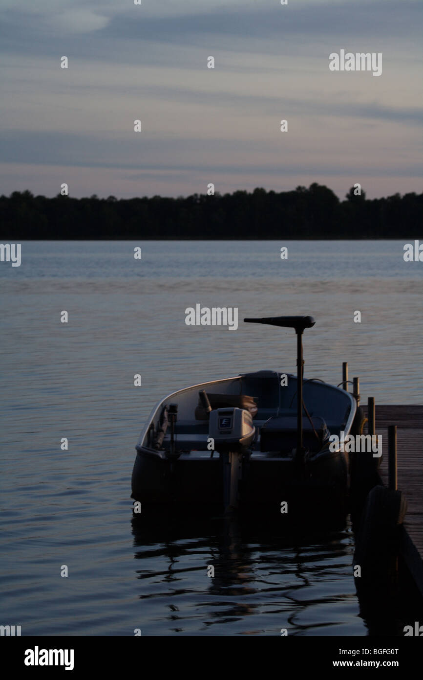 wooden boat ramp leading to boat and boat dock sitting on large fishing