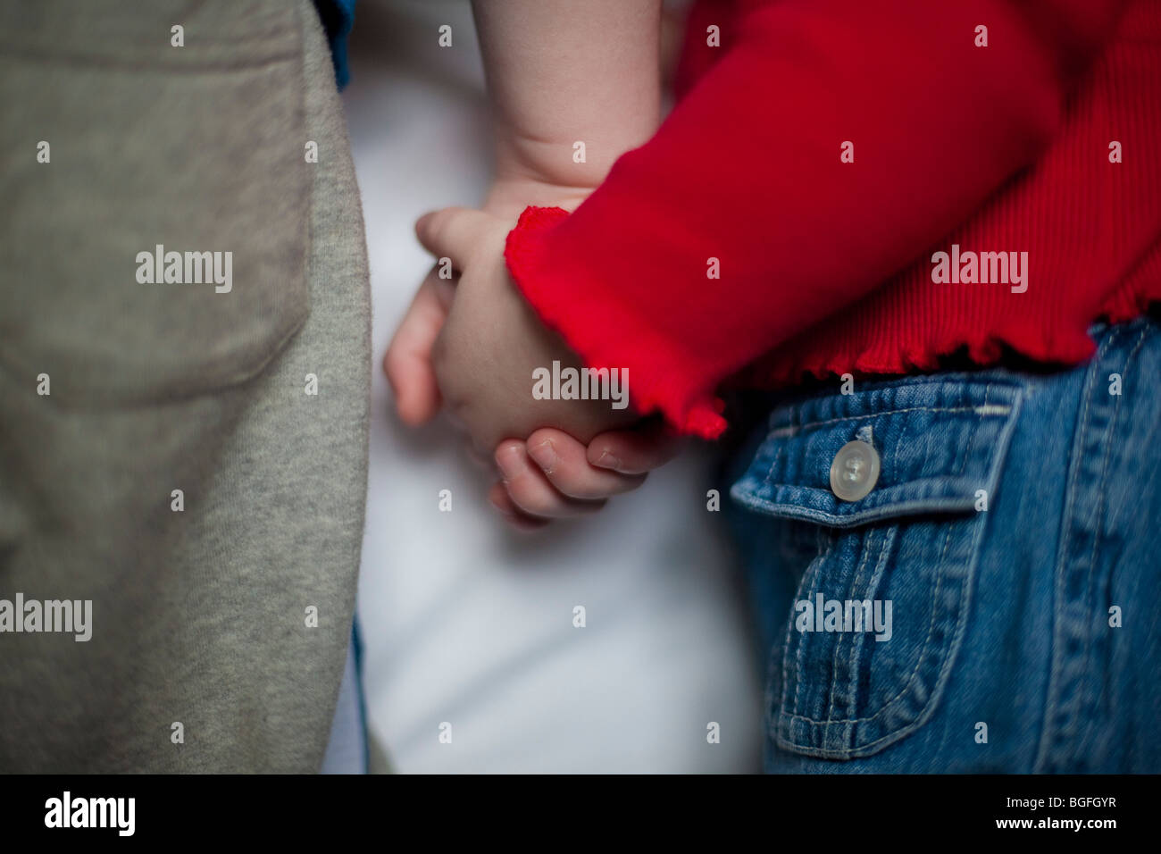 A young boy and girl holding hands Stock Photo - Alamy