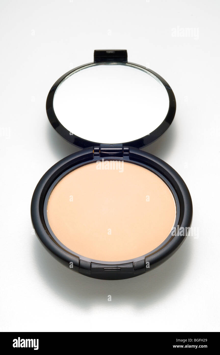 An opened cosmetics make-up compact with powder and mirror Stock Photo