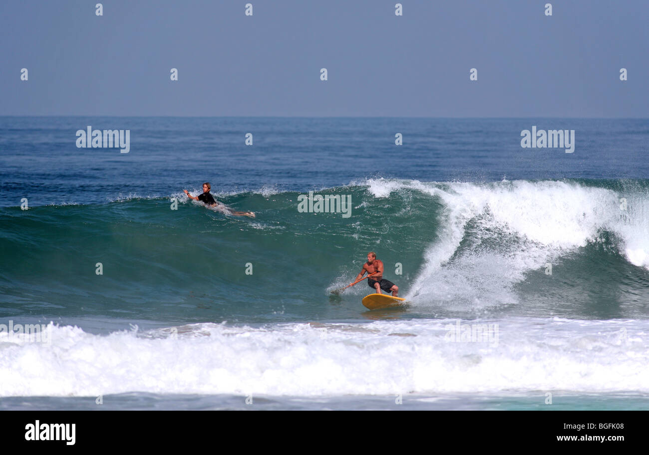Stand up paddle board surfer surfing on a wave at Puerto Escondido