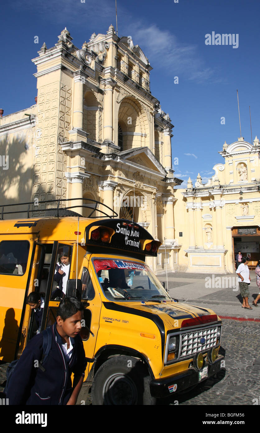 A schoolboy walks out of his bus in front of Iglesia de Hermano Pedro in Antigua Guatemala. Stock Photo