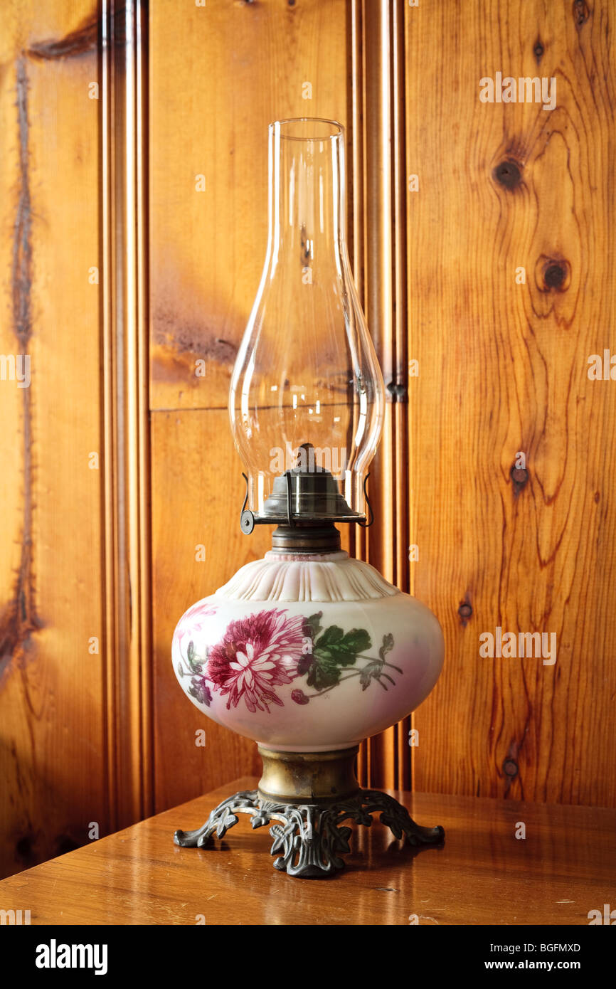 An antique oil lamp on a desk Stock Photo