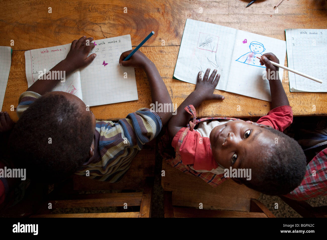 Boys draw at an orphanage in Kilimanjaro Region, Tanzania, East Africa. Stock Photo
