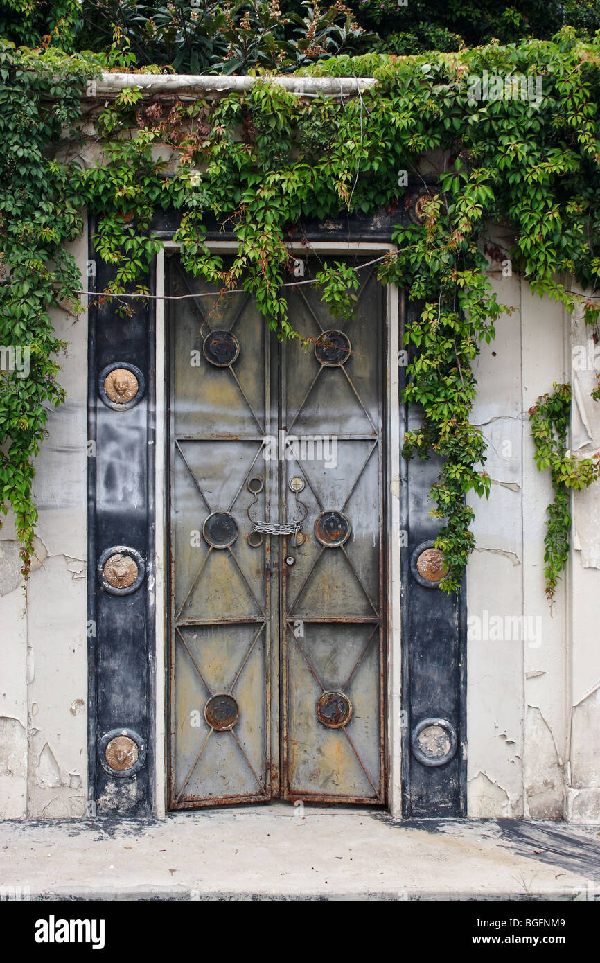 A dilapidated chained and padlocked ornate Mexican door in Ajijic, Mexico. Stock Photo
