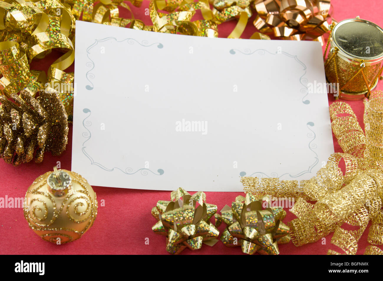 variety of gold metallic bows with a blank Christmas card with copyspace Stock Photo