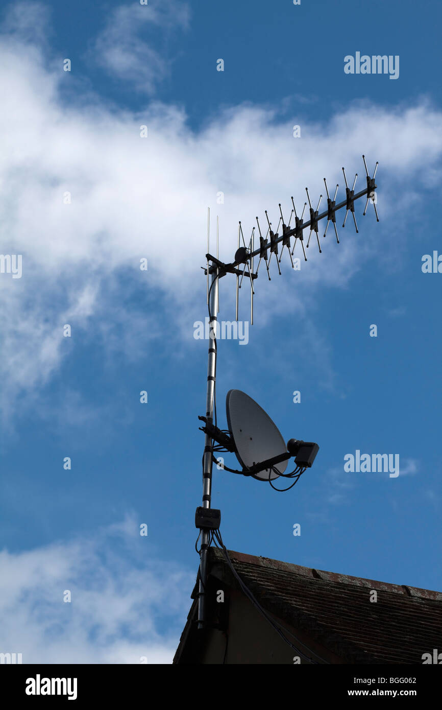a digital television satellite dish on top of a house Stock Photo