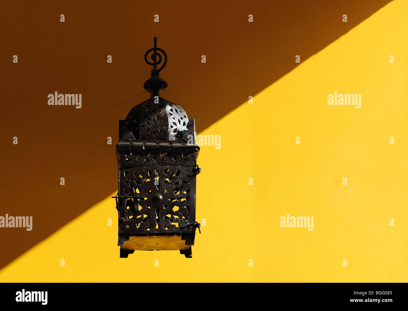 Lantern on a Yellow Wall Stock Photo