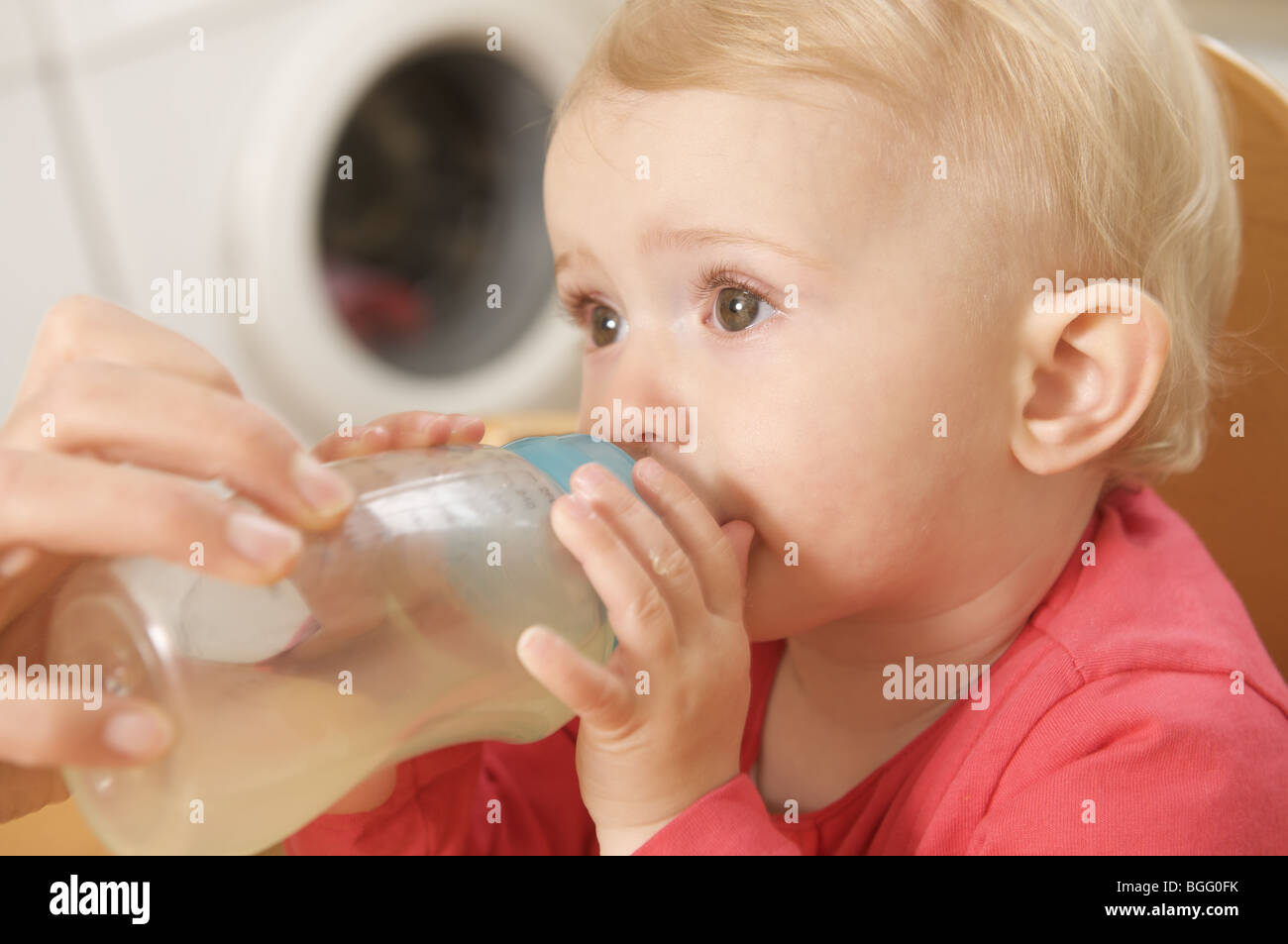 toddler drinking baby formula from bottle Stock Photo Alamy