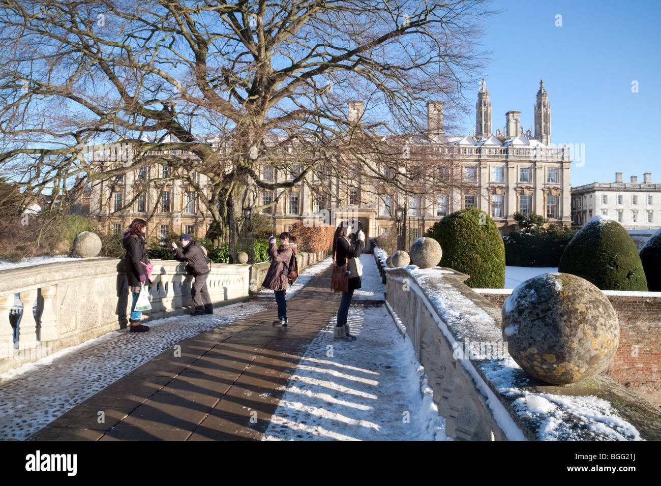Tourists in Clare College, Cambridge University as seen from Clare Bridge, in the snow, UK Stock Photo