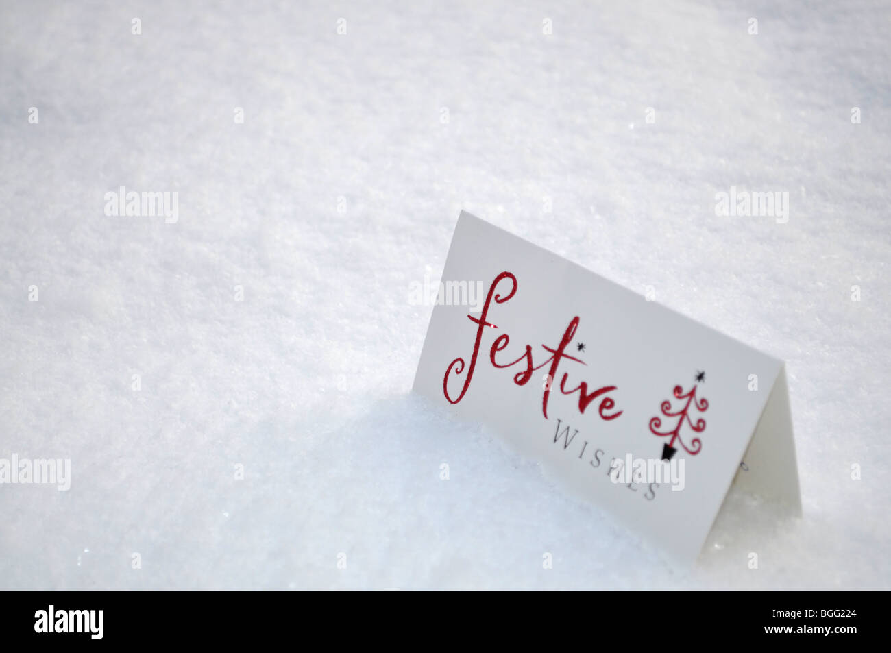 Christmas greeting card dropped in the snow Stock Photo