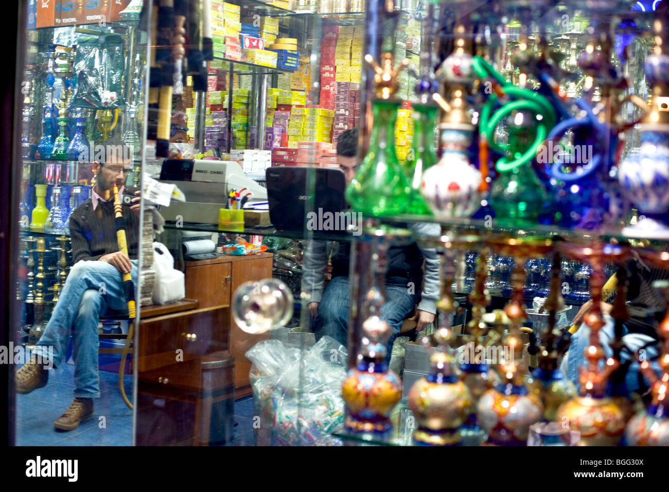 A man smoking water pipe nargile in a shop with water pipes, Kadikoy Asian part of Istanbul. Stock Photo