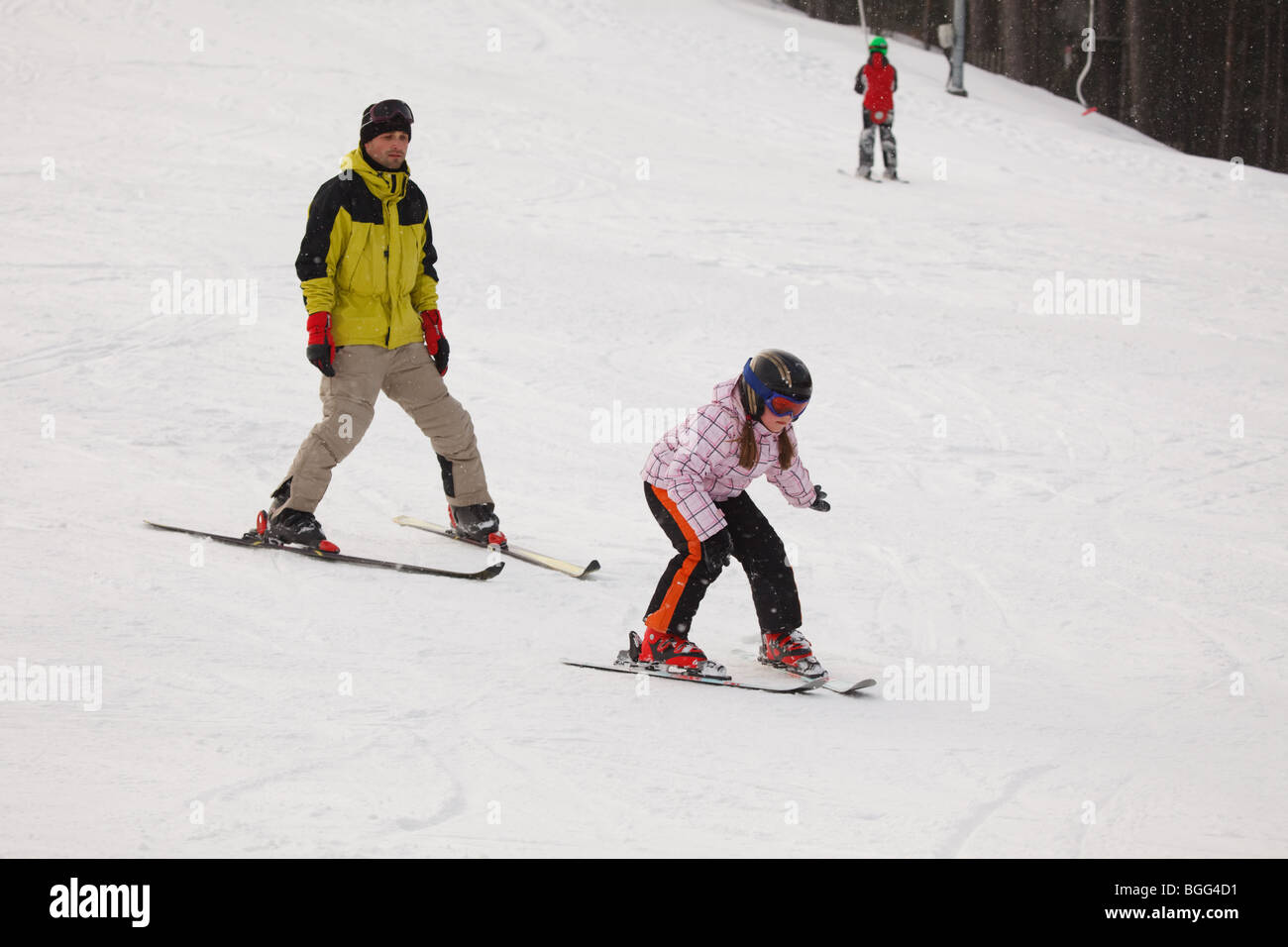 Instructor training little girl downhill alpine skiing Stock Photo Alamy