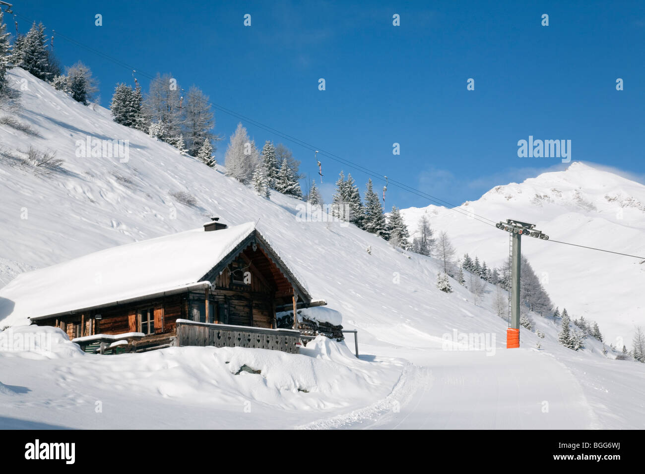 Rauris Austria Europe. Wooden chalet by Rauriser Hochalmbahnen ski slope piste in Austrian Alps