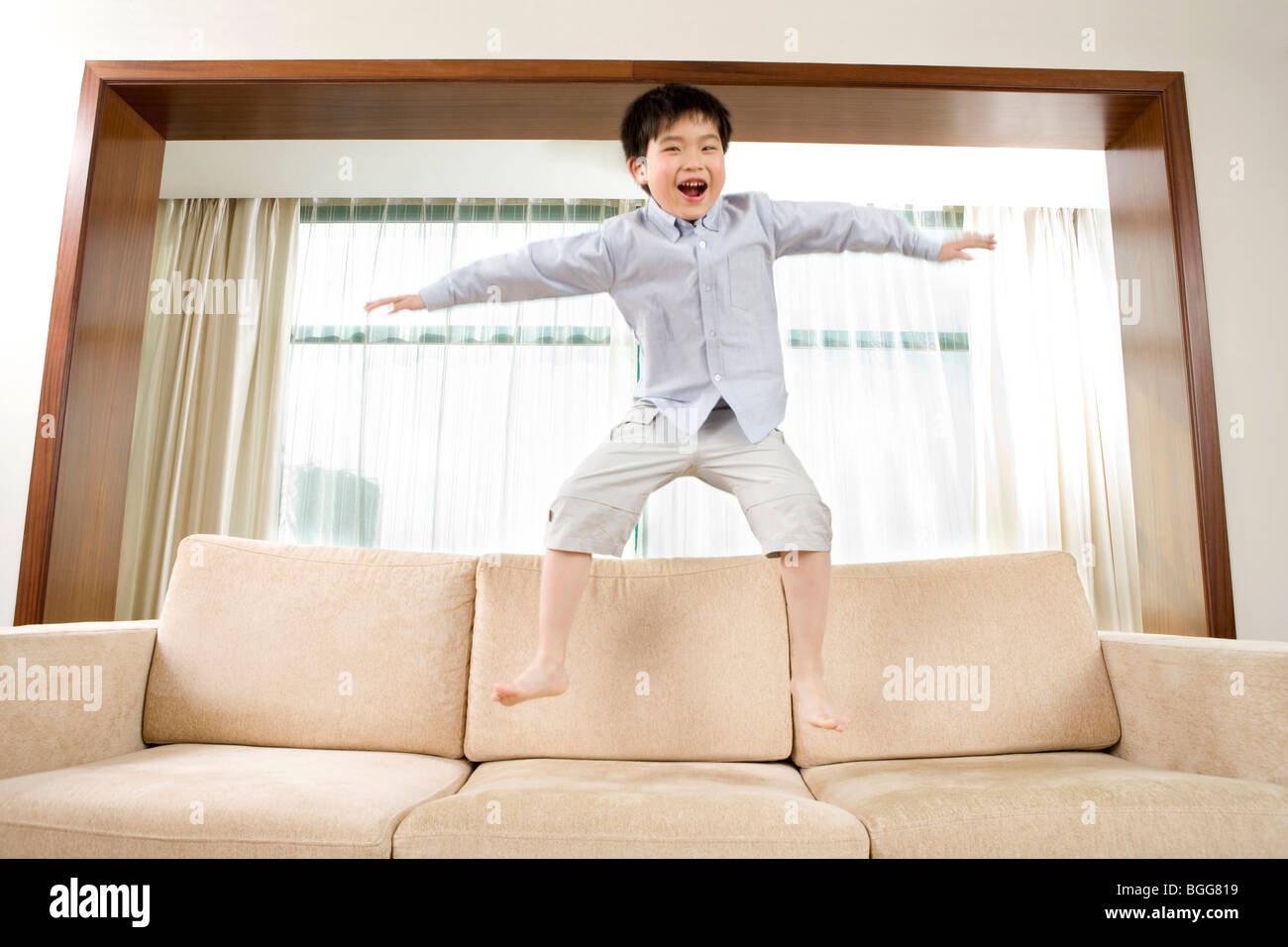 Child jumping on couch Stock Photo Alamy