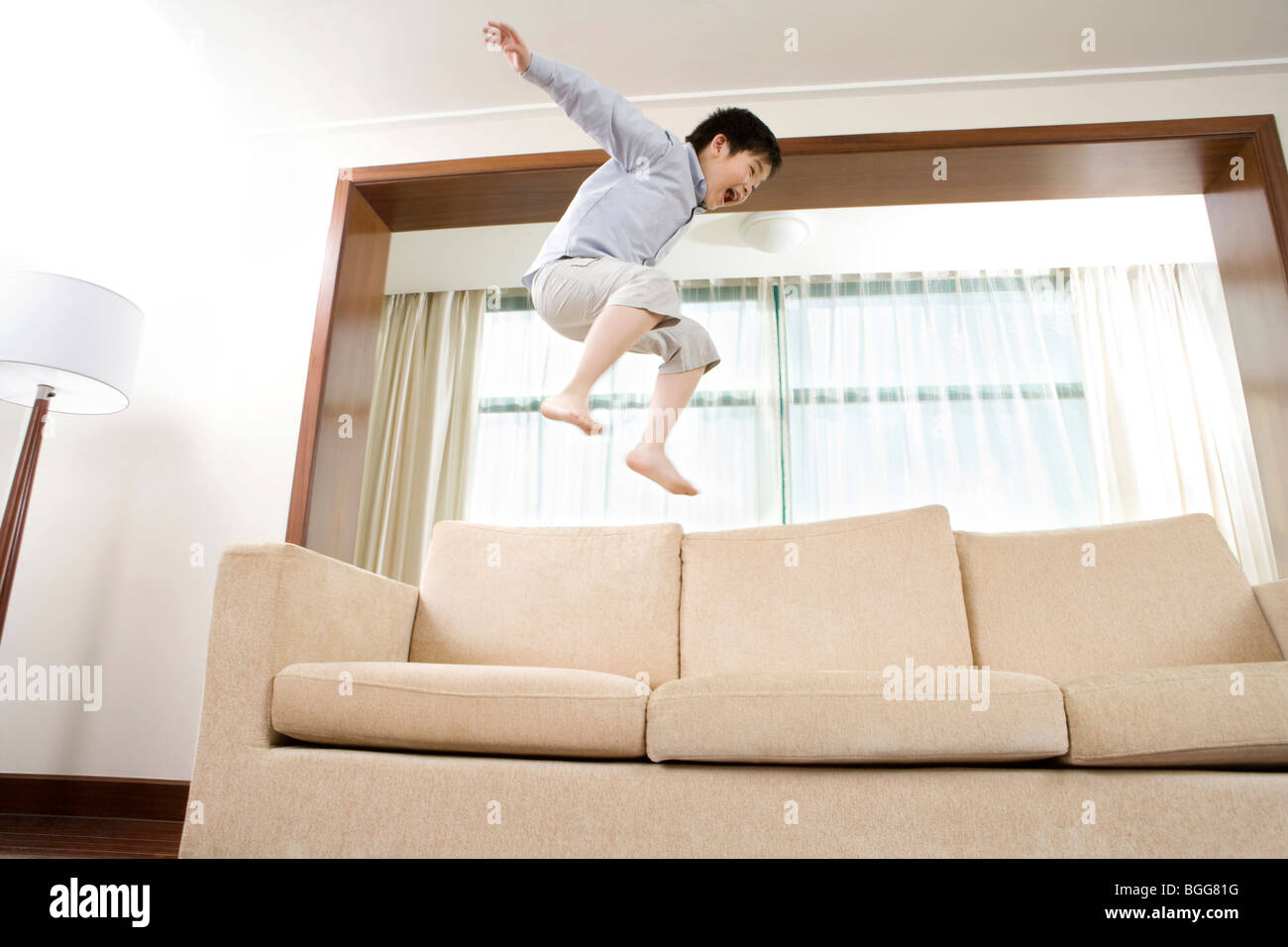 Child jumping on couch Stock Photo Alamy