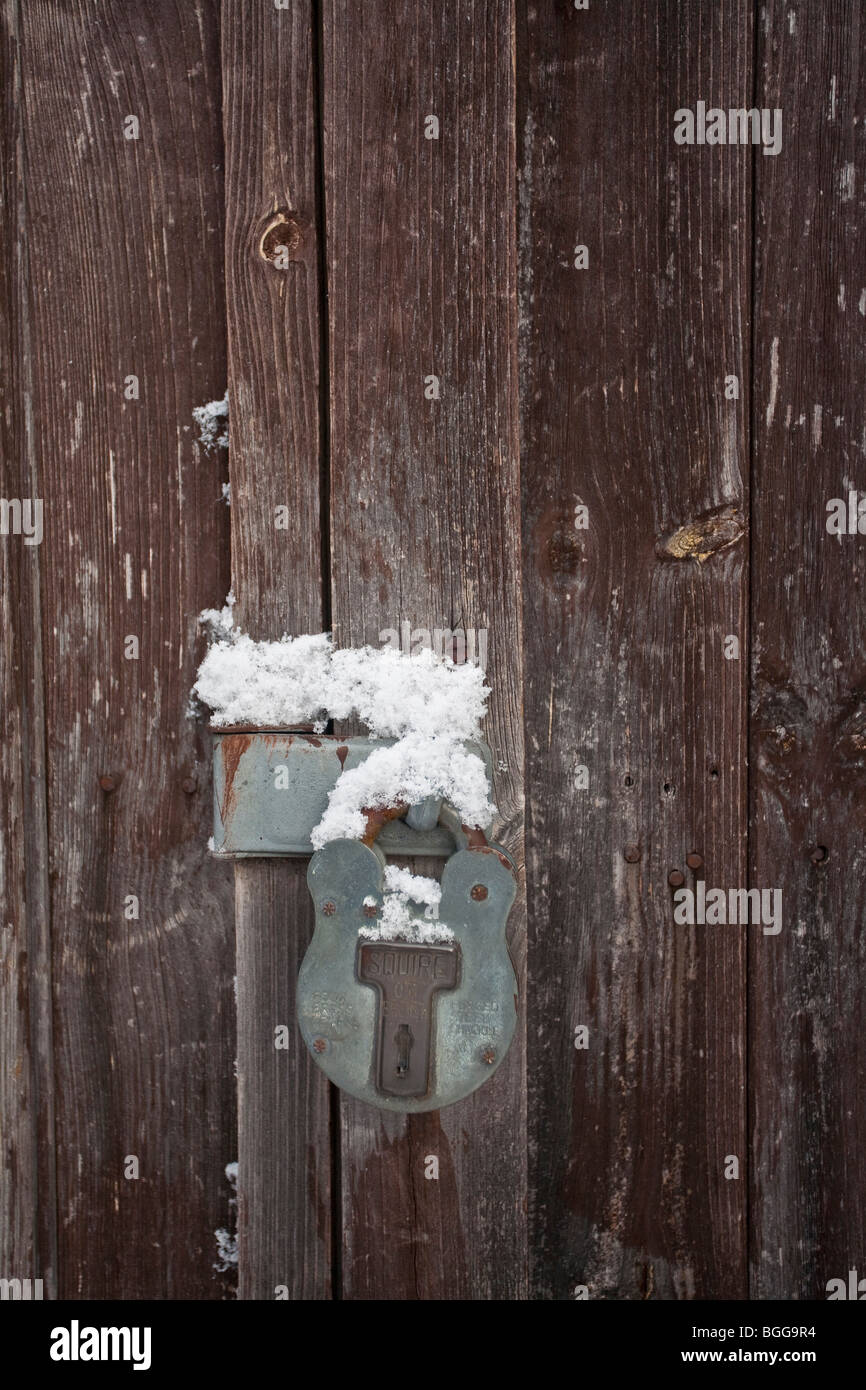 snow on an old rusty padlock Stock Photo
