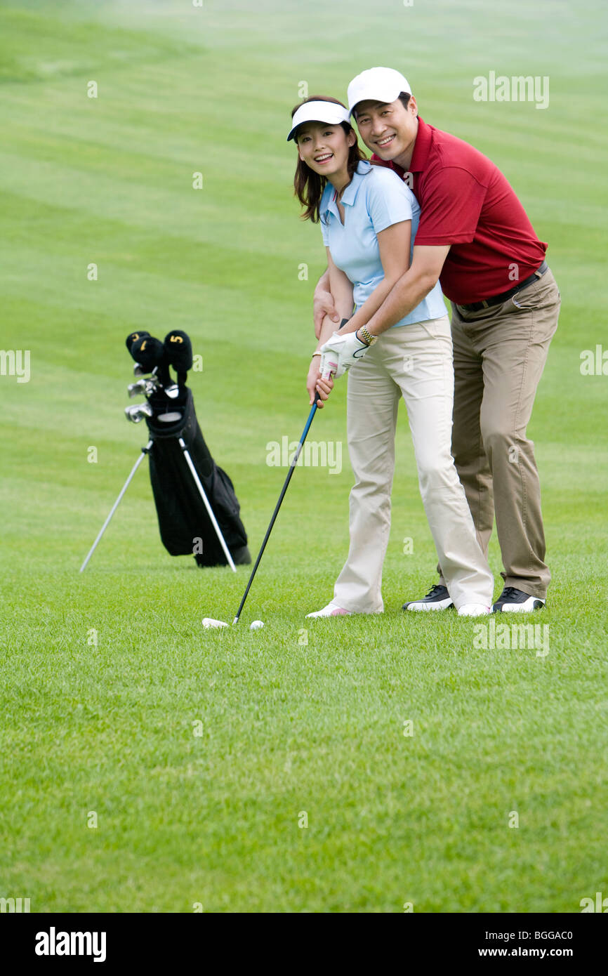Golf coach teaching playing golf Stock Photo - Alamy